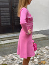 Knitted dress with sewn-on buttons